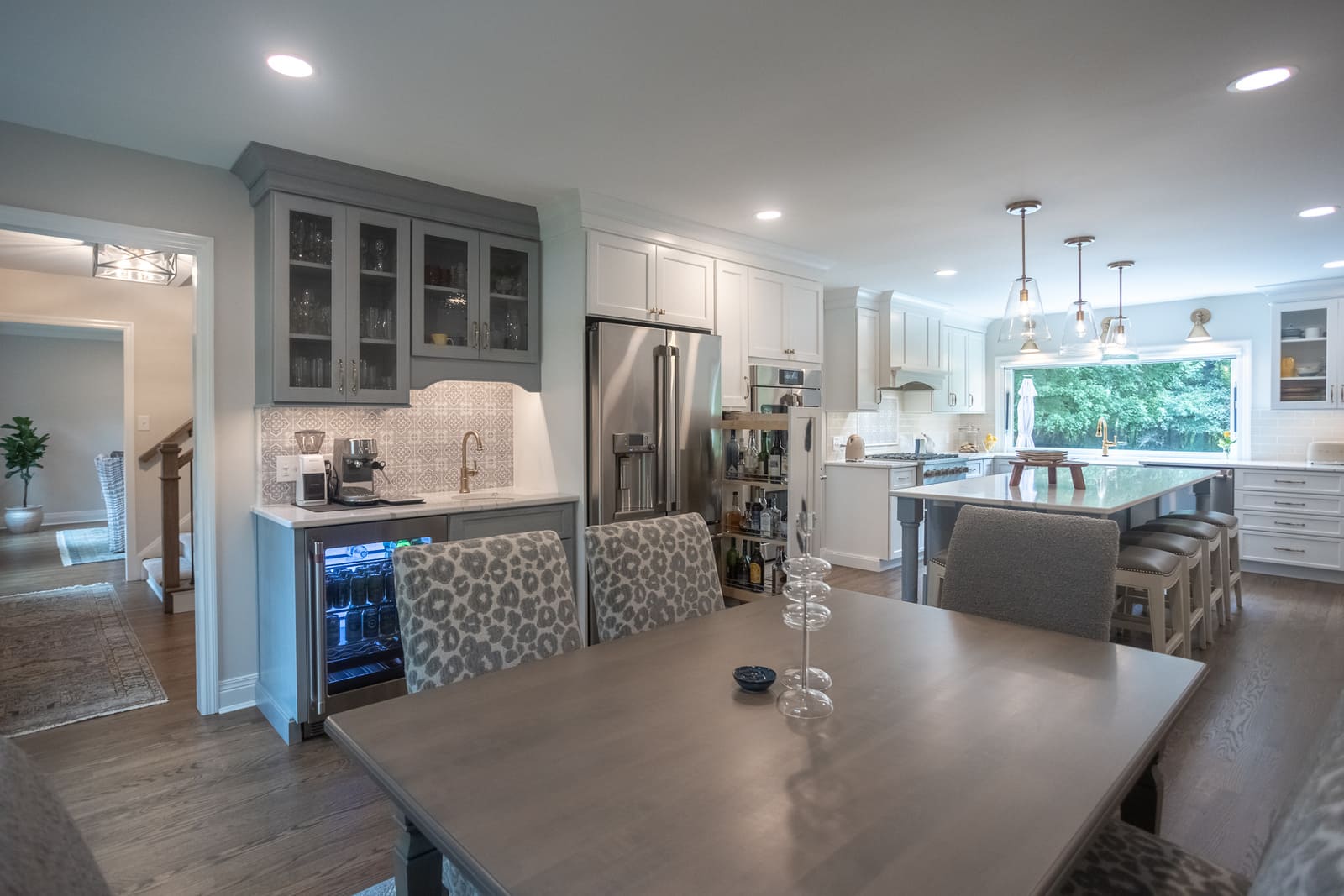 Kitchen remodel with beverage station and glass front cabinets by Legacy Builders