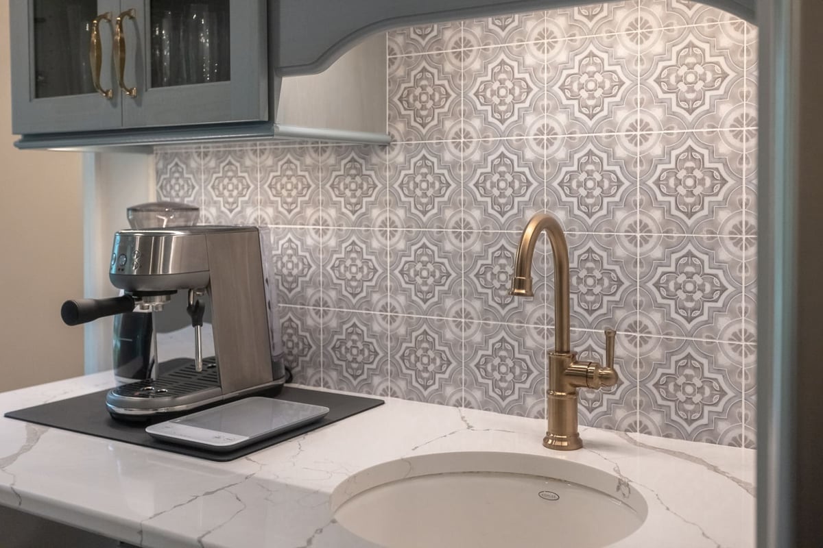 Beverage station with sink and mosaic backsplash by Legacy Builders