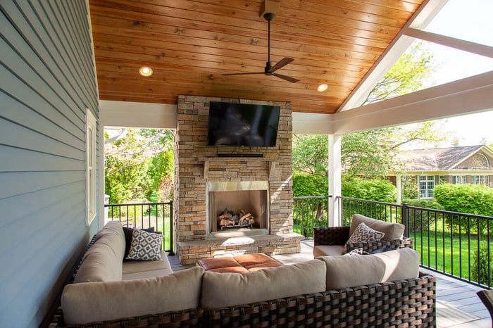 Covered porch with fireplace in Cincinnati by Legacy Builders