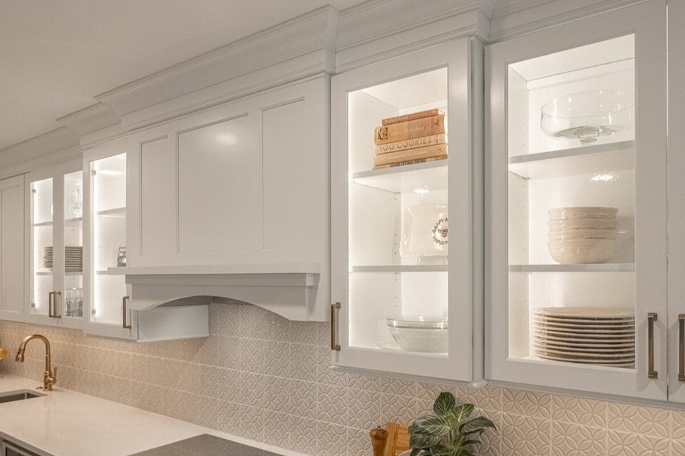 Glass-front cabinets above stove in Cincinnati, OH kitchen remodel by Legacy Builders