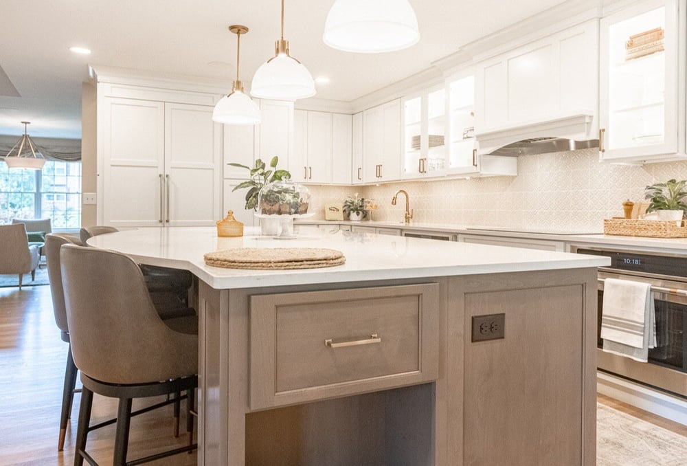 Oak flooring and quartz countertops on island in Cincinnati kitchen remodel by Legacy Builders