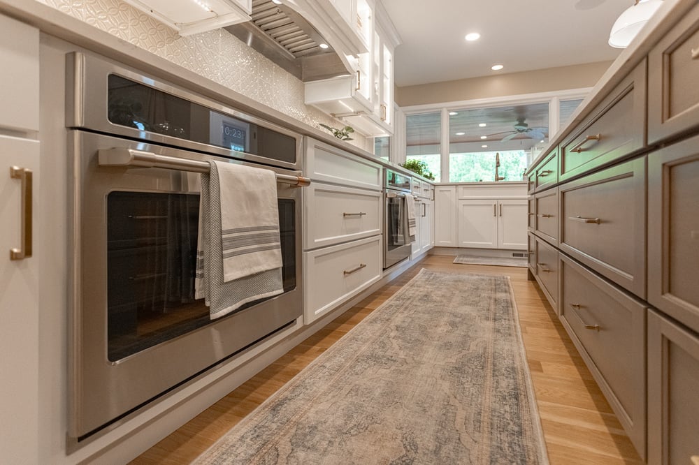 Pull-out cabinets and oven in two-tone kitchen remodel in Cincinnati by Legacy Builders