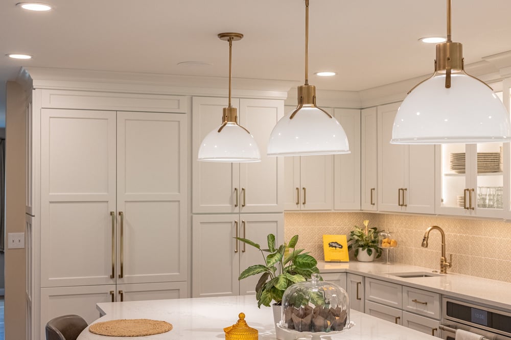 Three pendant lights with bronze above island in Cincinnati, OH kitchen remodel