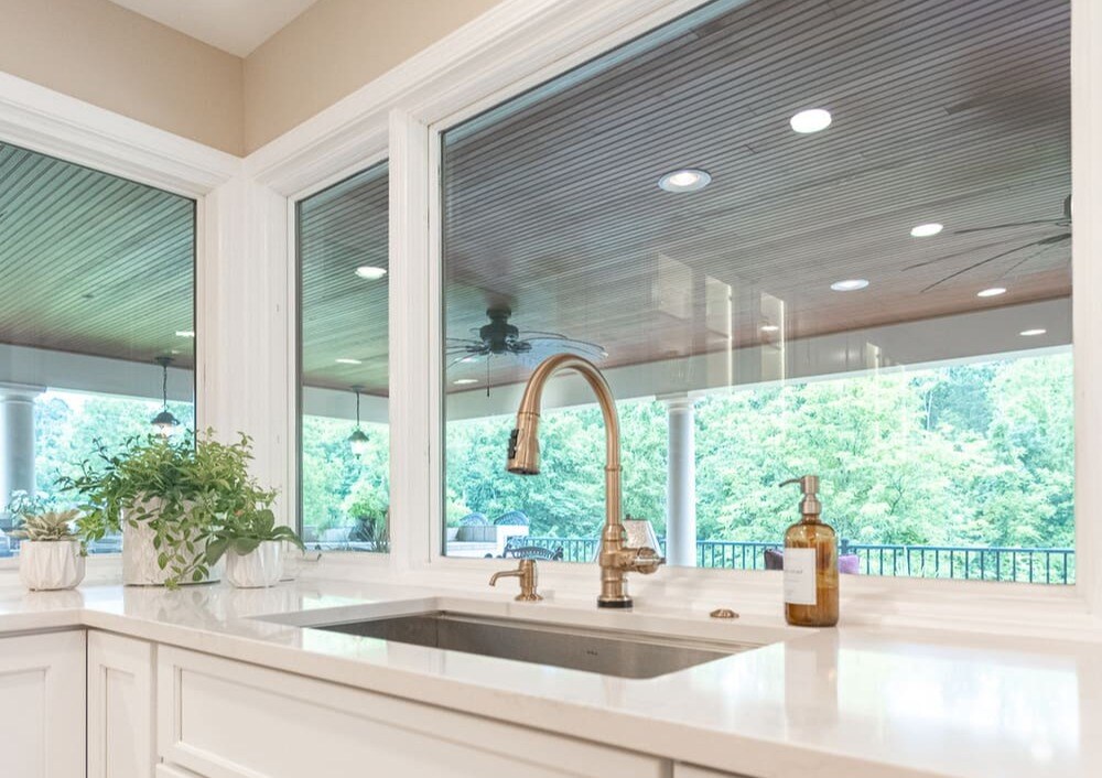 Windows behind sink in white kitchen remodel in Cincinnati by Legacy Builders