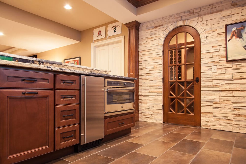 Arched door to wine cellar in Cincinnati basement remodel by Legacy Builders