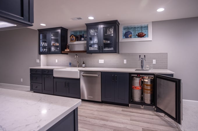 Basement renovation interior in Evendale, Ohio with built-in kegerator, sink, and dishwasher by Legacy Builders