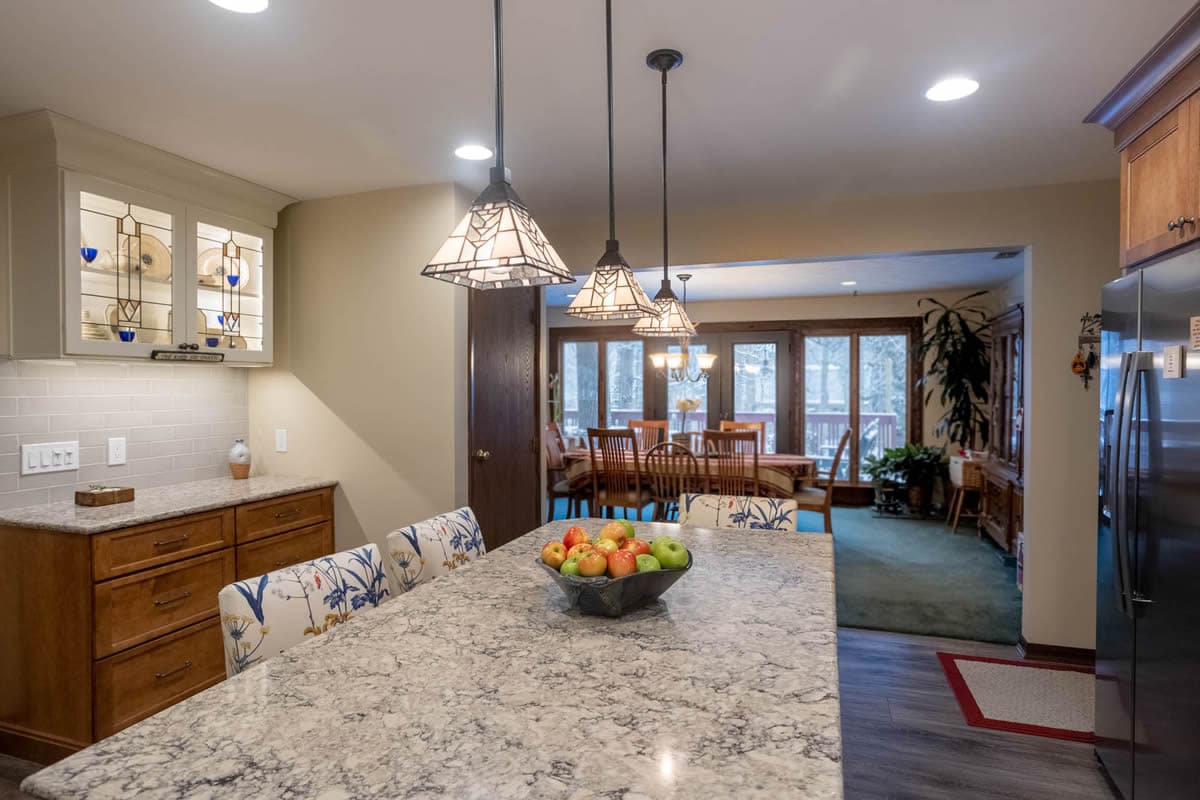 Cincinnati home remodel with three stained glass light pendants above kitchen island by Legacy Builders Group