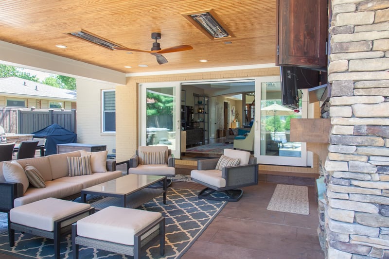 Covered patio by pool with ceiling fan and heaters by Legacy Builders in Cincinnati