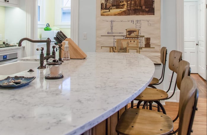 Island with quartz countertops and seating in Cincinnati kitchen remodel by Legacy Builders