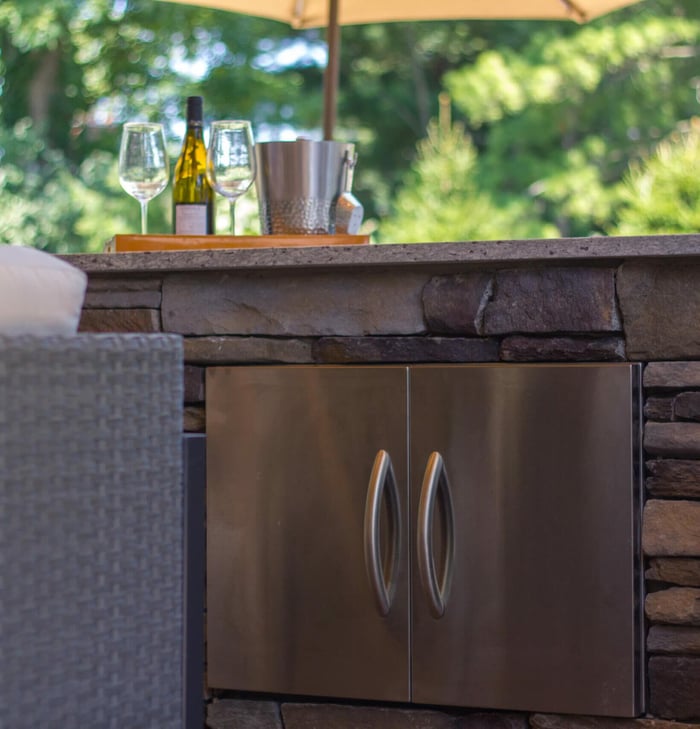 Outdoor kitchen in Cincinnati with built-in stainless steel cabinets by Legacy Builders