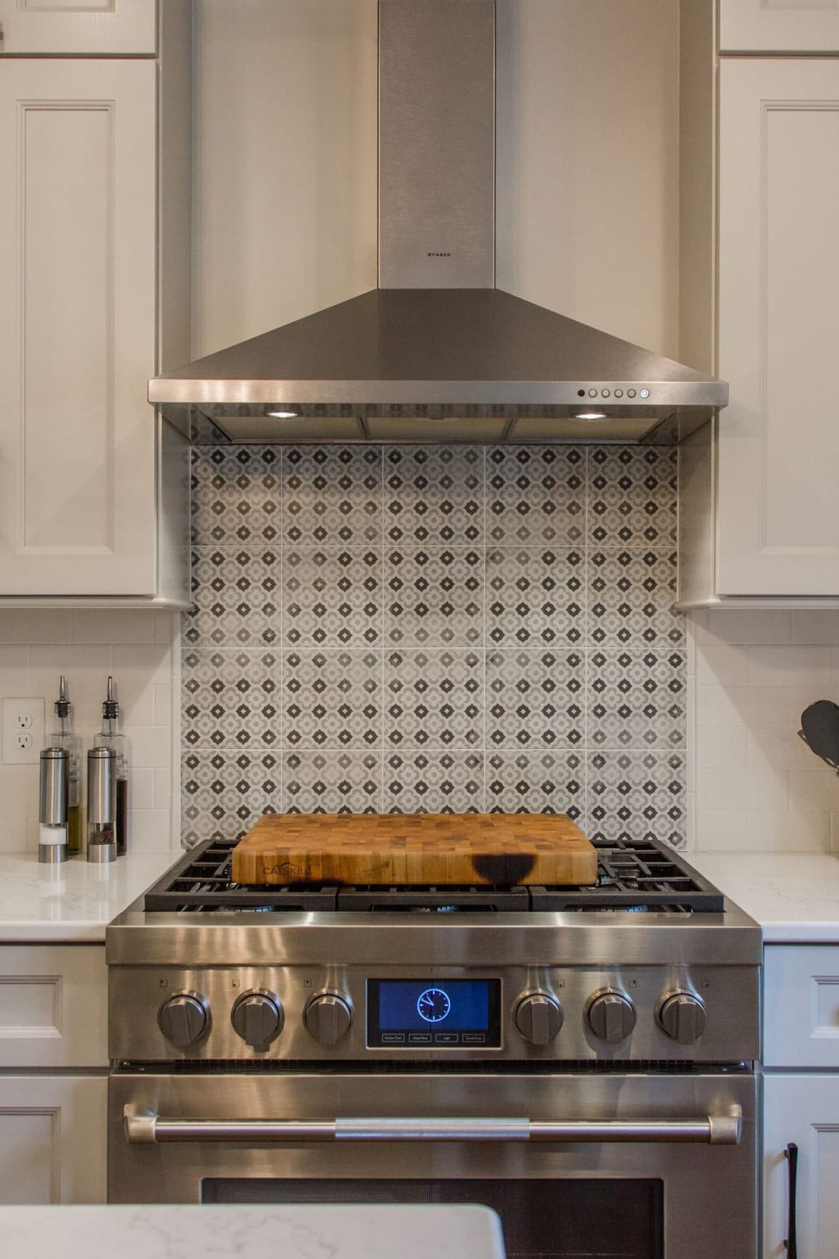 Pattern accent backsplash tile behind oven and range in Evendale, OH kitchen remodel by Legacy Builders