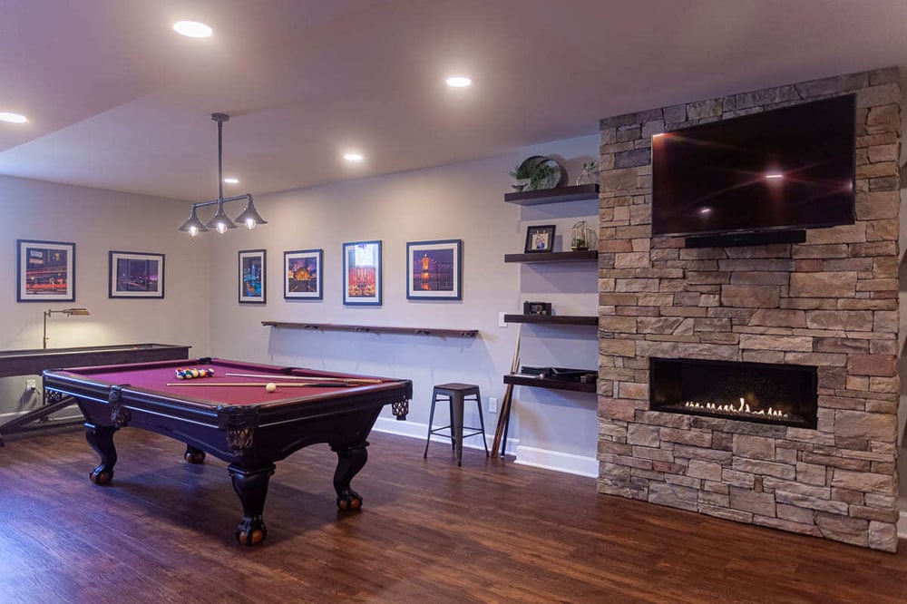 Pool table and fireplace in finished basement by Legacy Builders in Cincinnati, Ohio