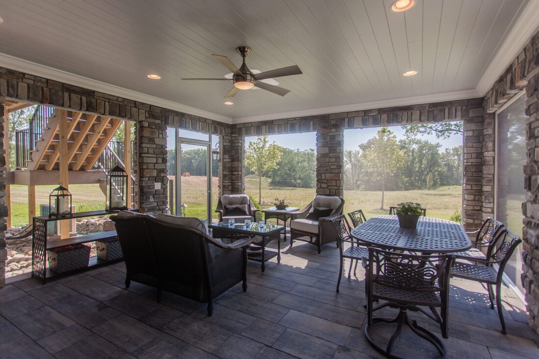 Sunroom with recessed lighting and stone wall features in Cincinnati home remodel by Legacy Builders