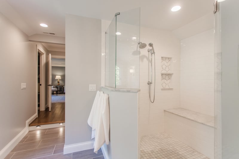 Walk-in shower with bench and shelf in Cincinnati bathroom remodel by Legacy Builders