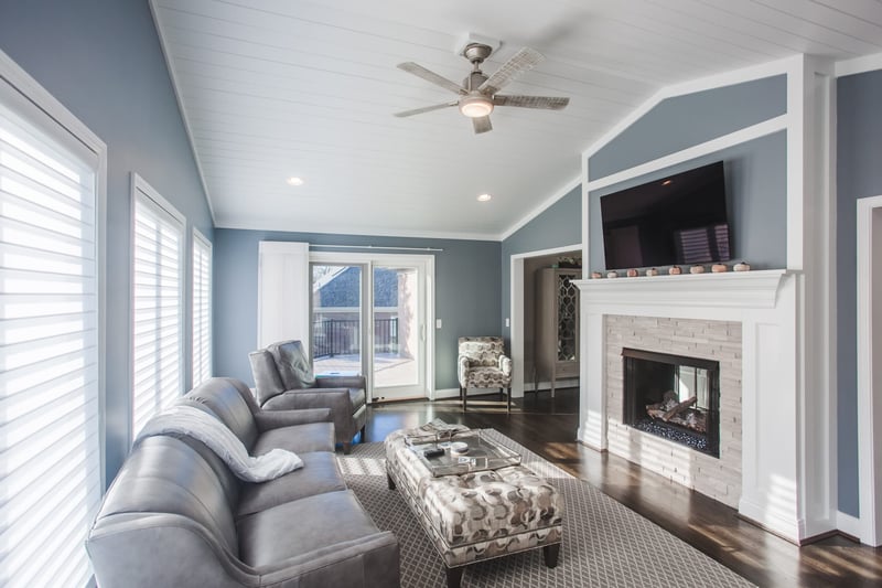 White Oak, OH home addition with white brick fireplace and recessed lighting by Legacy Builders