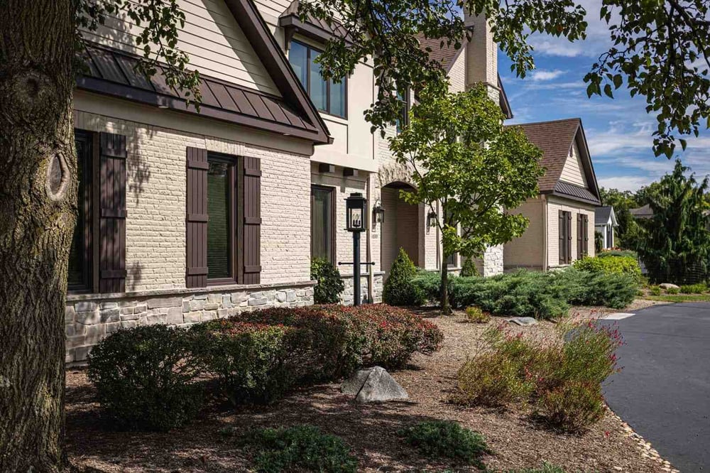 Exterior facade of renovation with brown window shutters