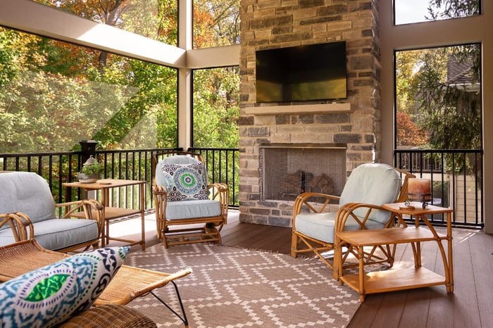 Screened-in porch with composite decking and fireplace in Evendale, OH by Legacy Builders