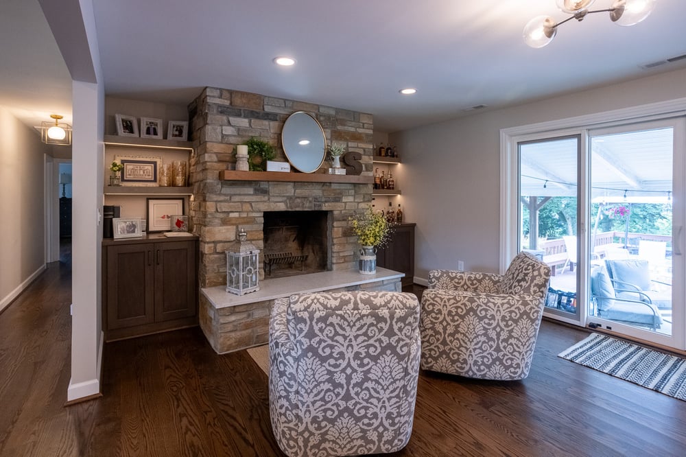 Two chairs in front of fireplace in main floor of White Oak, OH home remodel by Legacy Builders