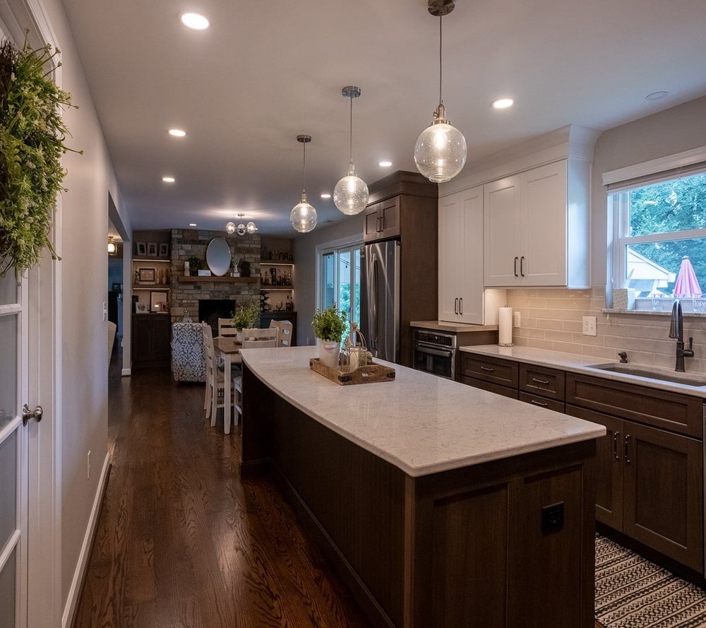 Two tone kitchen remodel with two pendulum lights above island in White Oak, OH by Legacy Builders