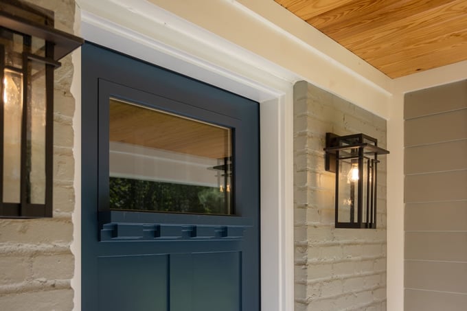 Up-close detail of front door with painted brick exterior in Montgomery, OH outdoor living remodel