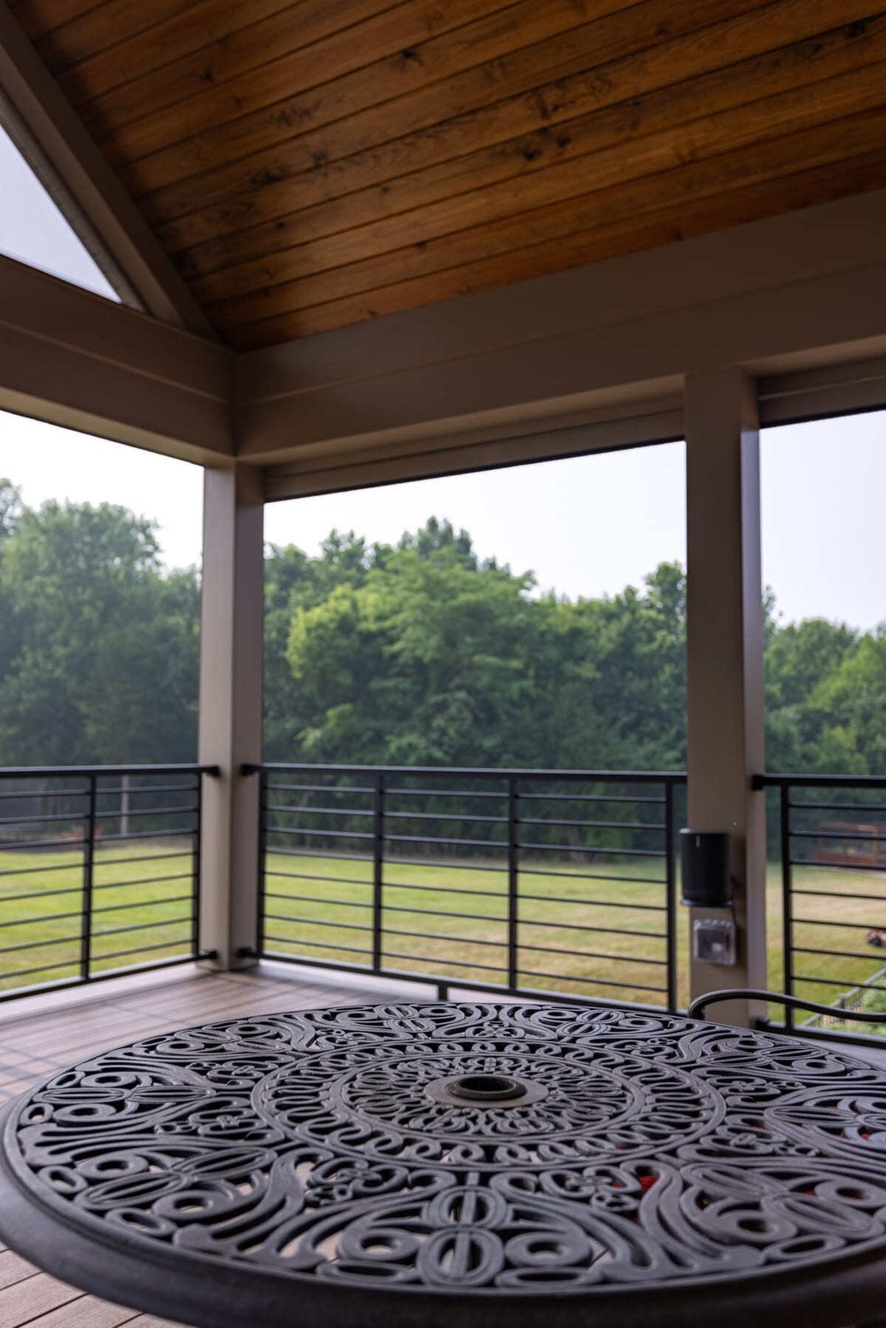 Aluminum railing on covered deck in Cincinnati, OH outdoor living space by Legacy Builders