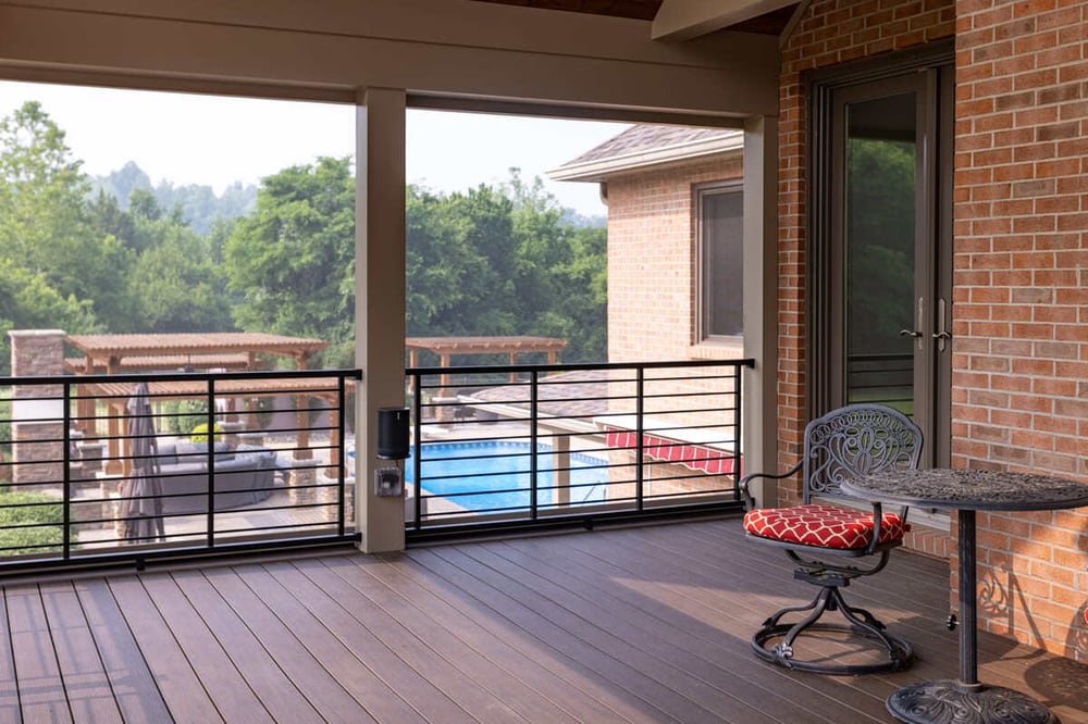 Chair and table on covered deck with view of Cincinnati, OH backyard