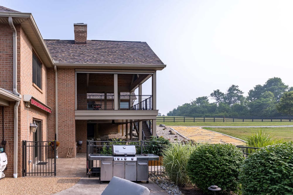 Outdoor living space in Cincinnati, Ohio featuring a concrete patio and cooking area by Legacy Builders