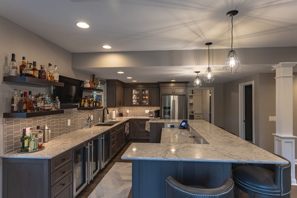 View of basement bar in Ross County renovation with custom cabinetry and wine fridge