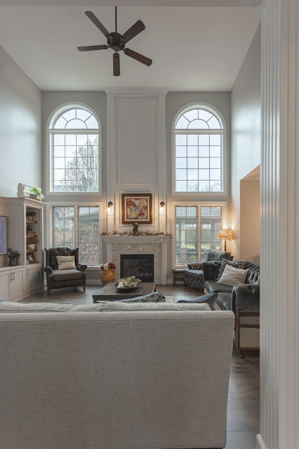 First floor remodel in Cincinnati, OH with arched windows and modern brick fireplace